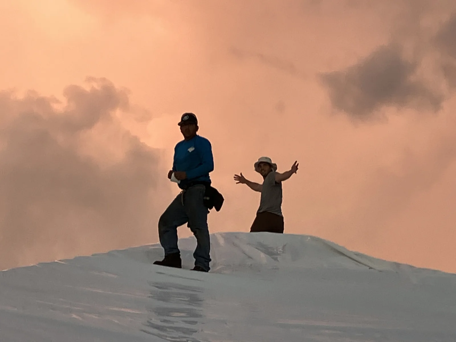 Obieo founder and crew on a jobsite roof at golden hour